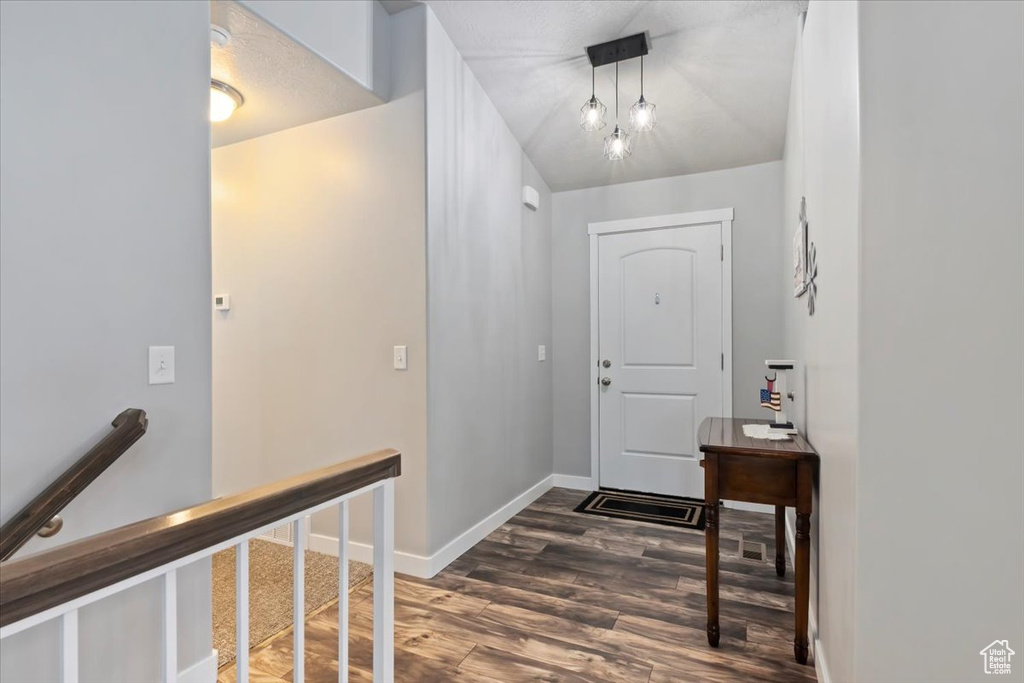 Foyer featuring wood finished floors and baseboards