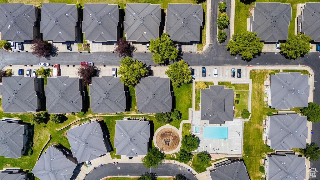 Aerial overview of property's location with nearby suburban area and a pool area