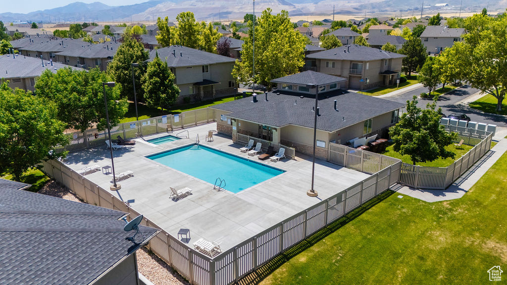 Community pool featuring a residential view, a patio, and a mountain view