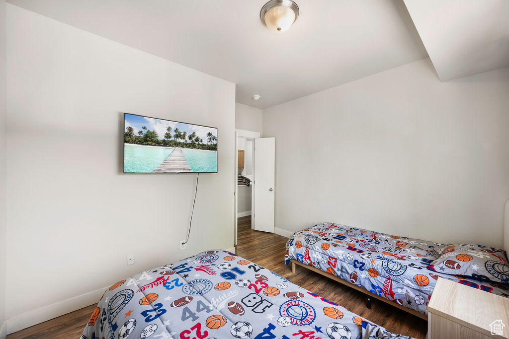 Bedroom with wood finished floors and baseboards