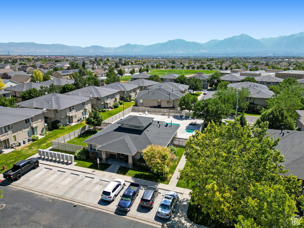 Aerial view of residential area featuring mountains and a pool area