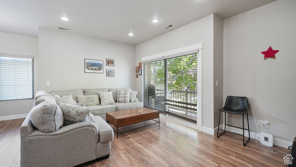 Living room with wood finished floors and recessed lighting