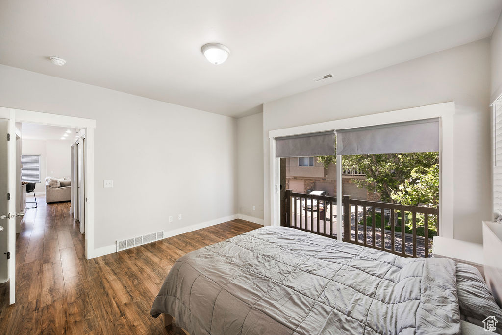 Bedroom with access to outside and wood finished floors