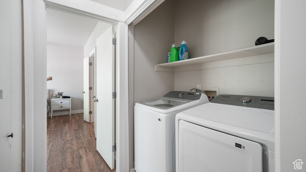 Washroom with separate washer and dryer and wood finished floors