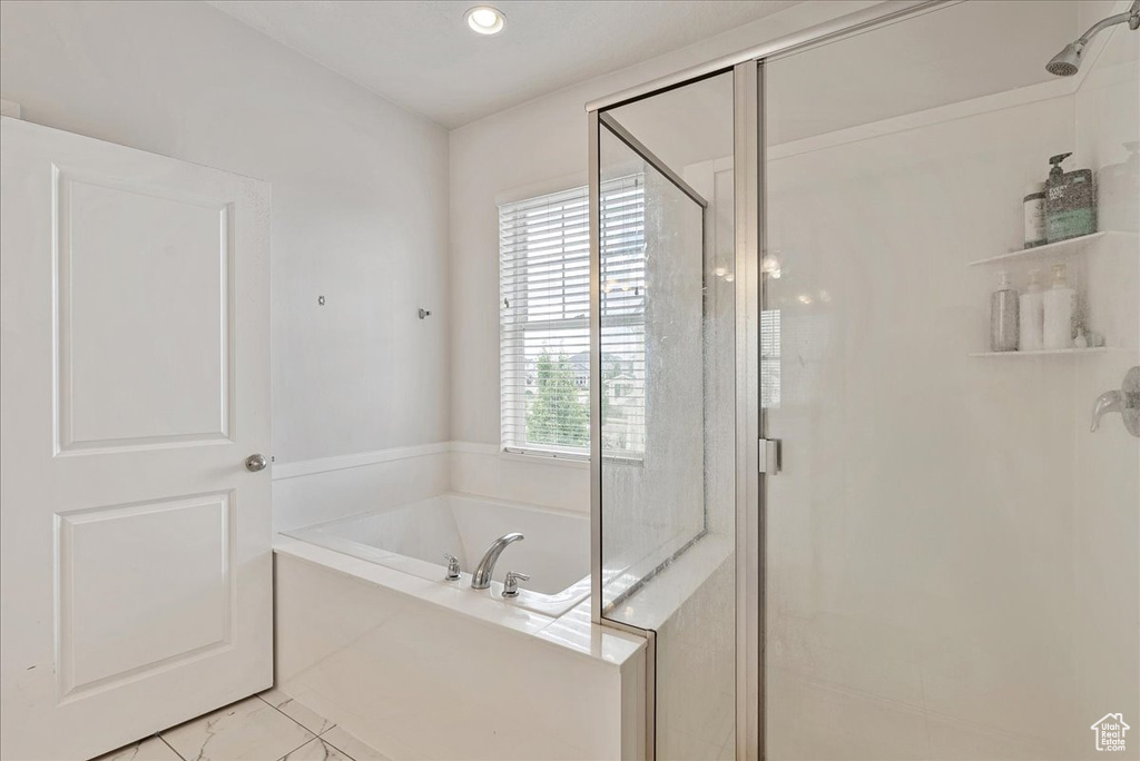 Full bath featuring a stall shower and a garden tub