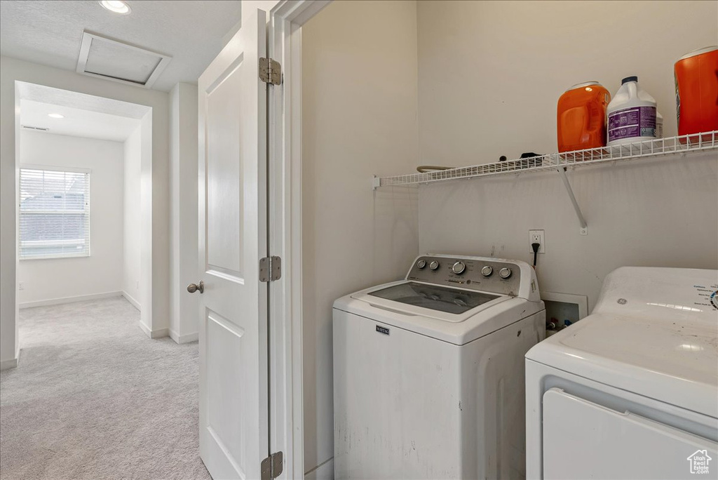 Laundry room featuring light colored carpet, washer and clothes dryer, attic access, and recessed lighting