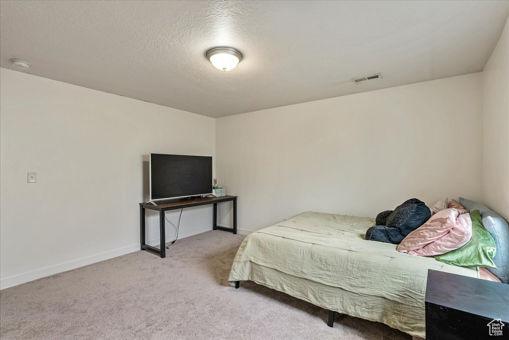Bedroom featuring carpet and baseboards