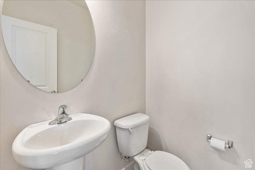 Half bathroom featuring a sink and toilet