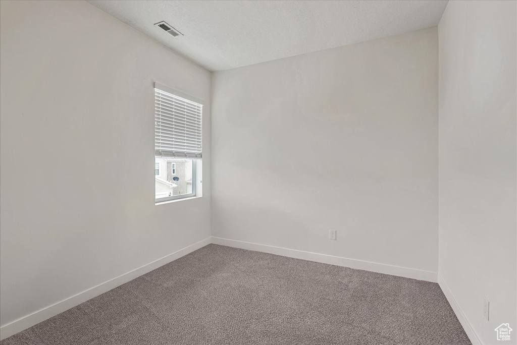 Empty room with carpet flooring