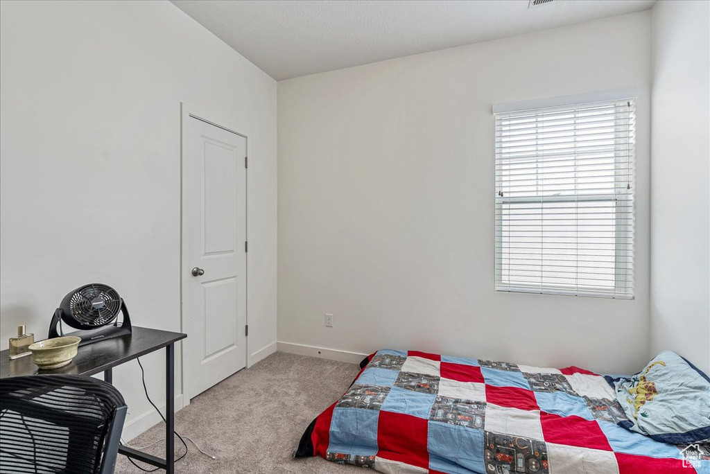 Carpeted bedroom with baseboards