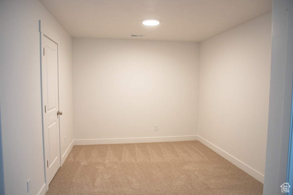 Spare room with light carpet and recessed lighting