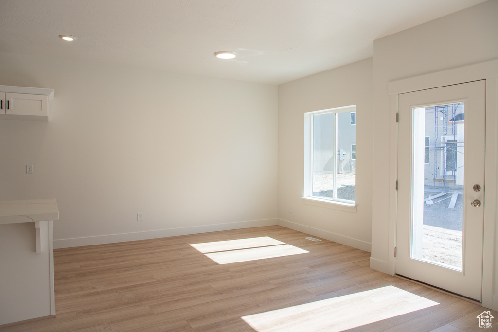 Unfurnished living room featuring light wood-style floors and recessed lighting