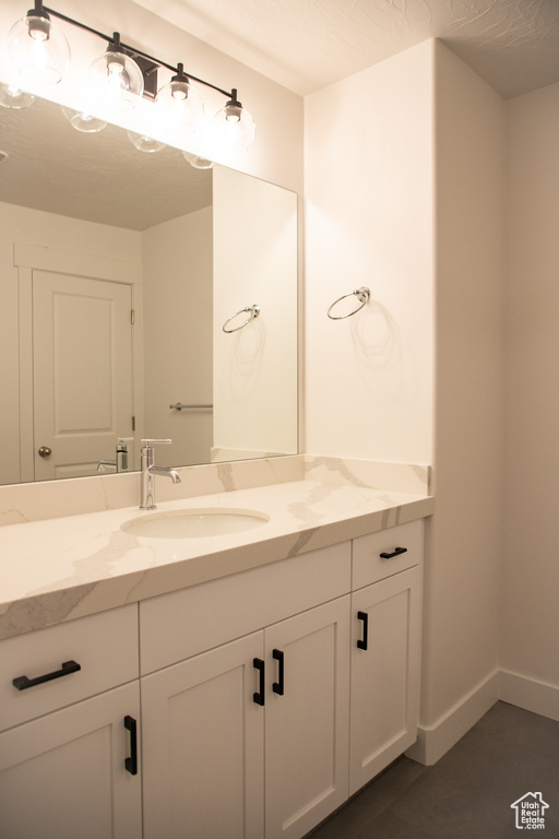 Bathroom featuring vanity and baseboards