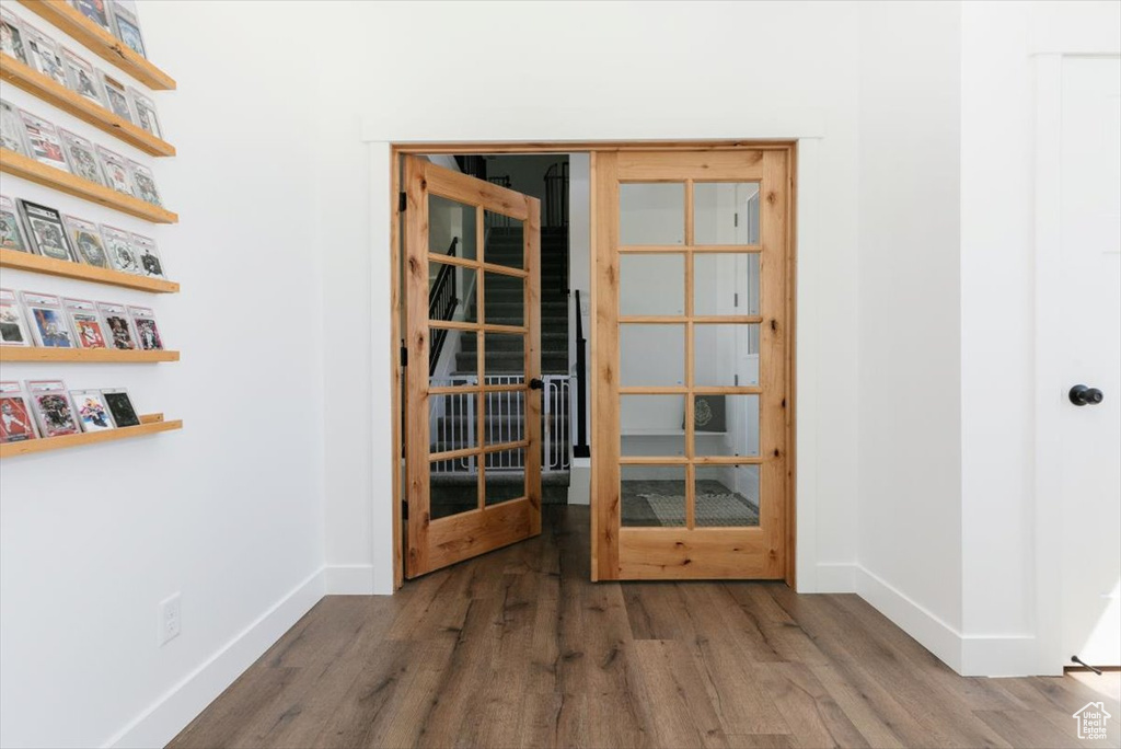 Spare room with baseboards and wood finished floors