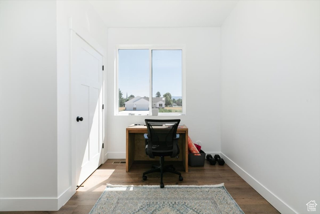 Office with wood finished floors
