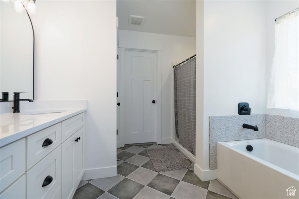 Full bathroom with vanity, a bath, and a shower with shower curtain