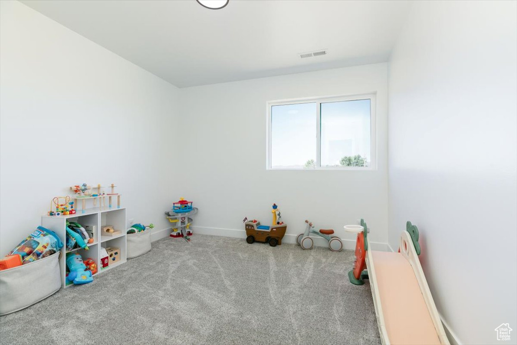 Recreation room featuring carpet floors and baseboards
