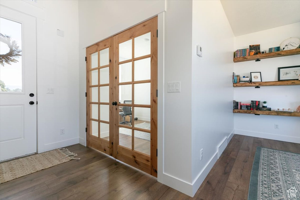 Foyer with french doors and wood-type flooring