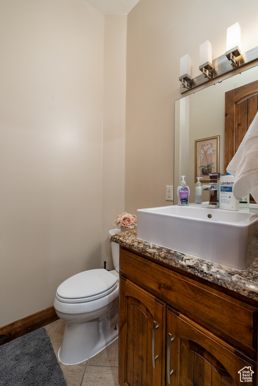 Half bathroom with vanity and toilet