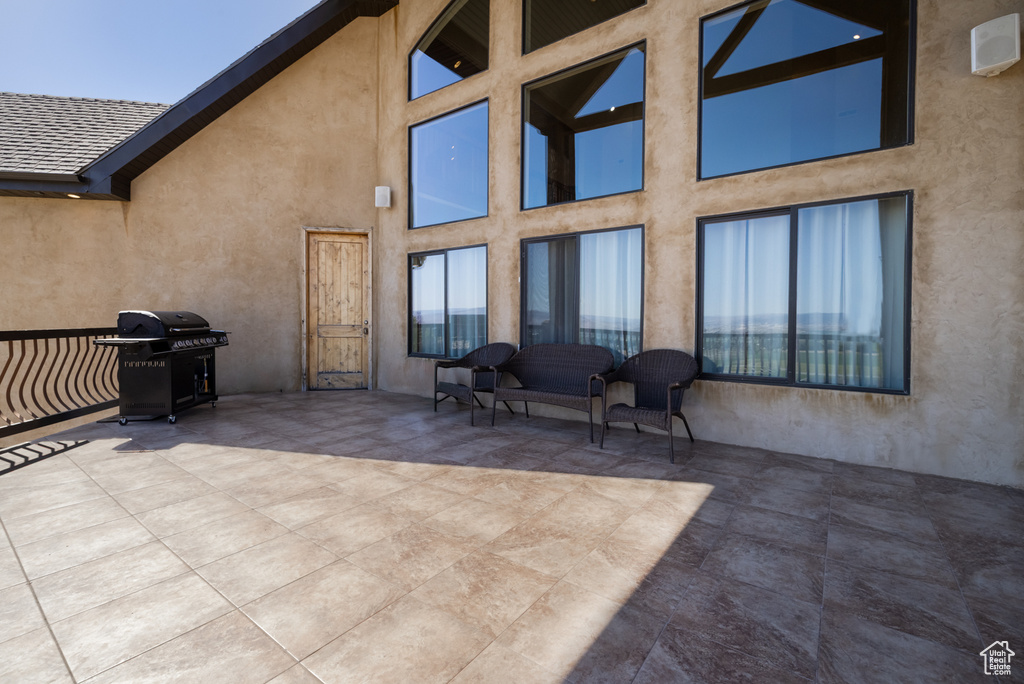 Back of house with stucco siding and a patio