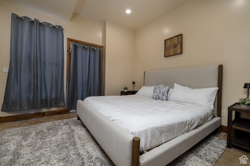 Tiled bedroom with recessed lighting