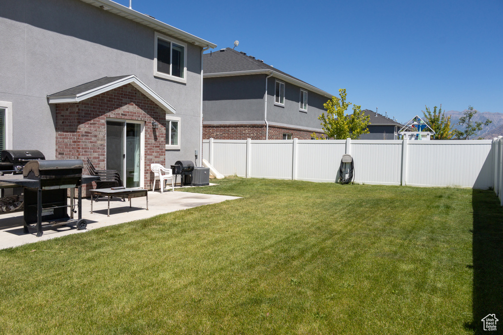 Fenced backyard with a patio area