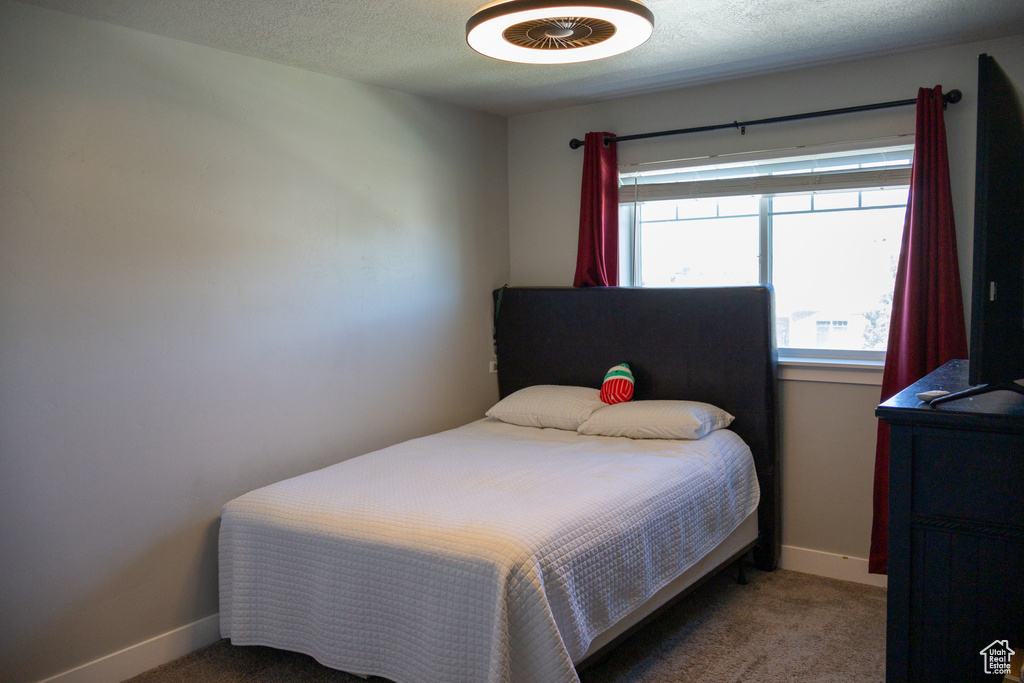 Bedroom with carpet and a textured ceiling