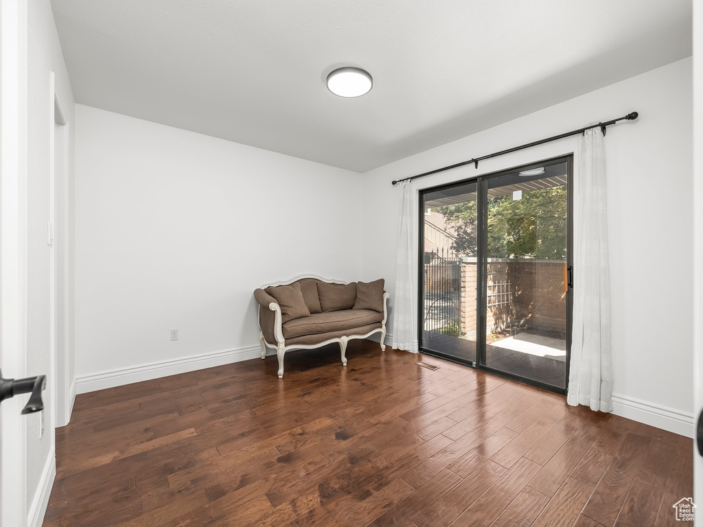 Sitting room with wood finished floors and baseboards