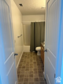 Bathroom with vanity, shower / bath combination with curtain, and tile patterned floors