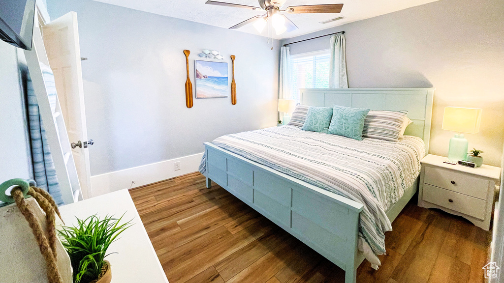 Bedroom with wood finished floors and ceiling fan