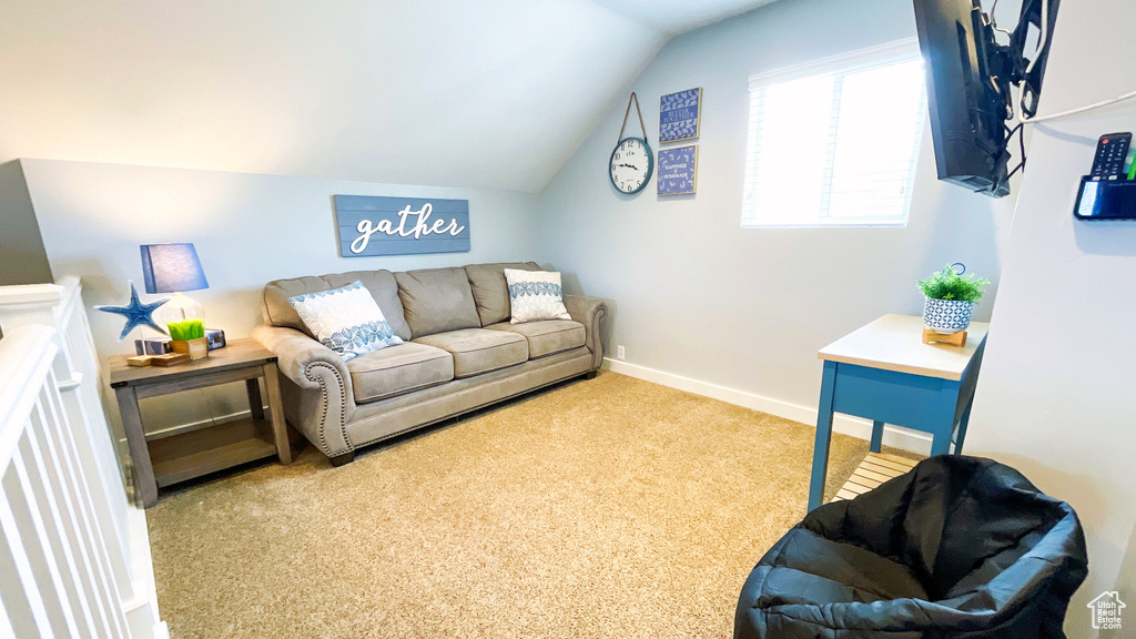Living room featuring lofted ceiling and carpet floors