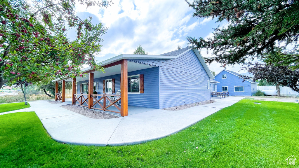 View of side of property with a yard