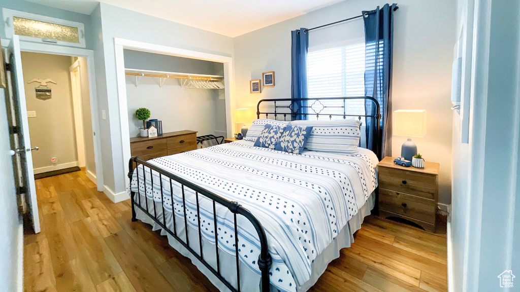 Bedroom featuring wood finished floors and a closet