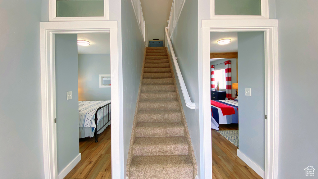 Staircase featuring wood finished floors and baseboards