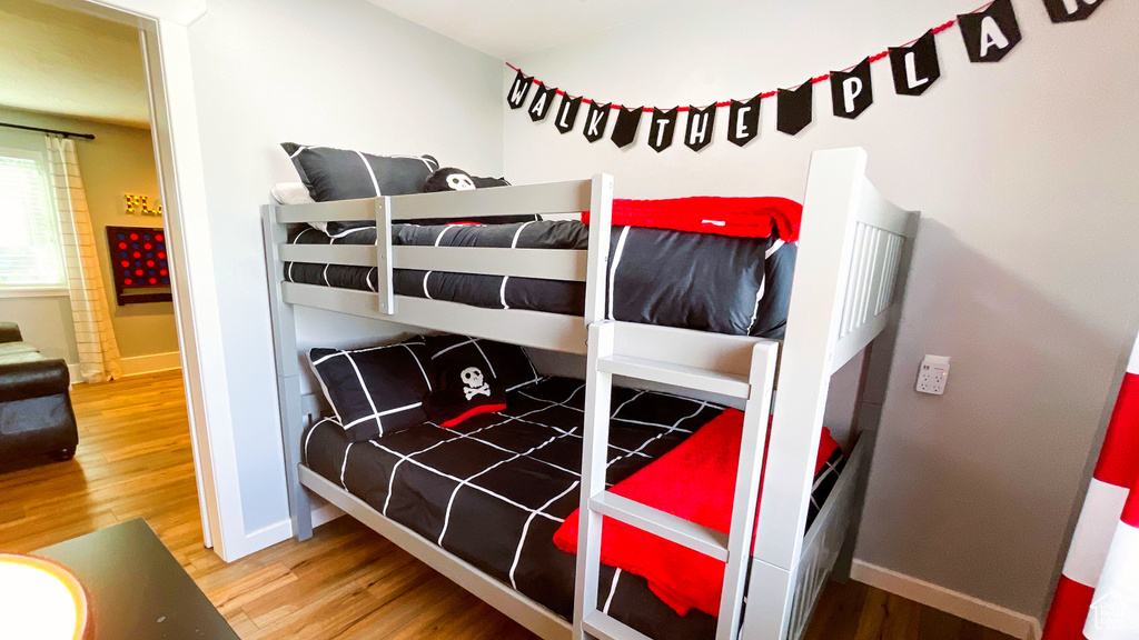 Bedroom featuring wood finished floors and baseboards