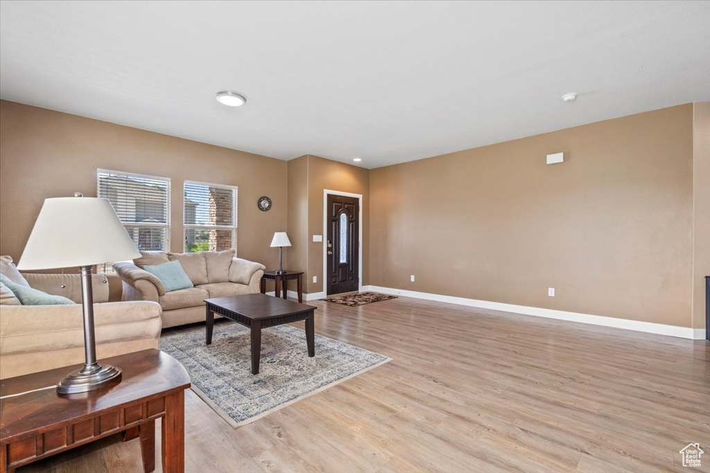 Living room with baseboards and light wood-type flooring