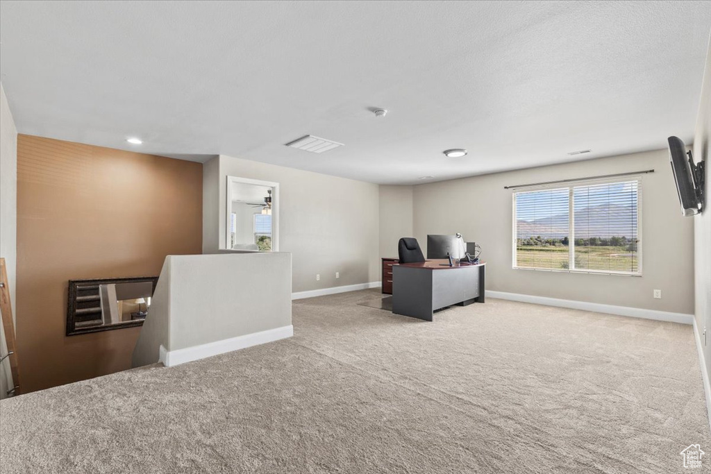 Office with carpet flooring and baseboards