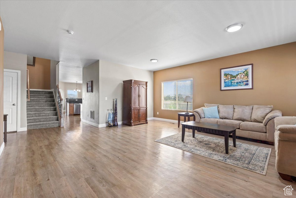 Living room with stairway and wood finished floors