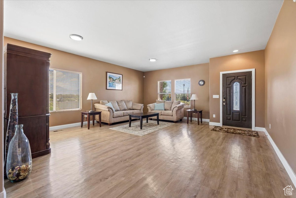 Living area featuring wood finished floors and recessed lighting