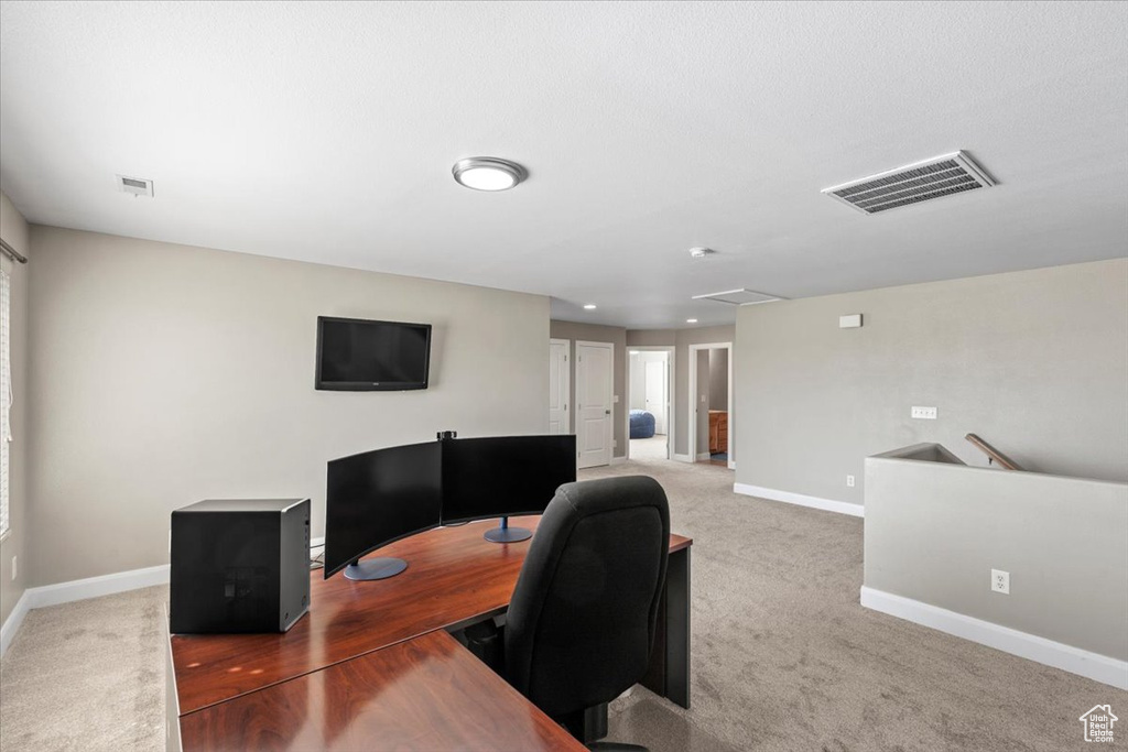 Carpeted office space with baseboards