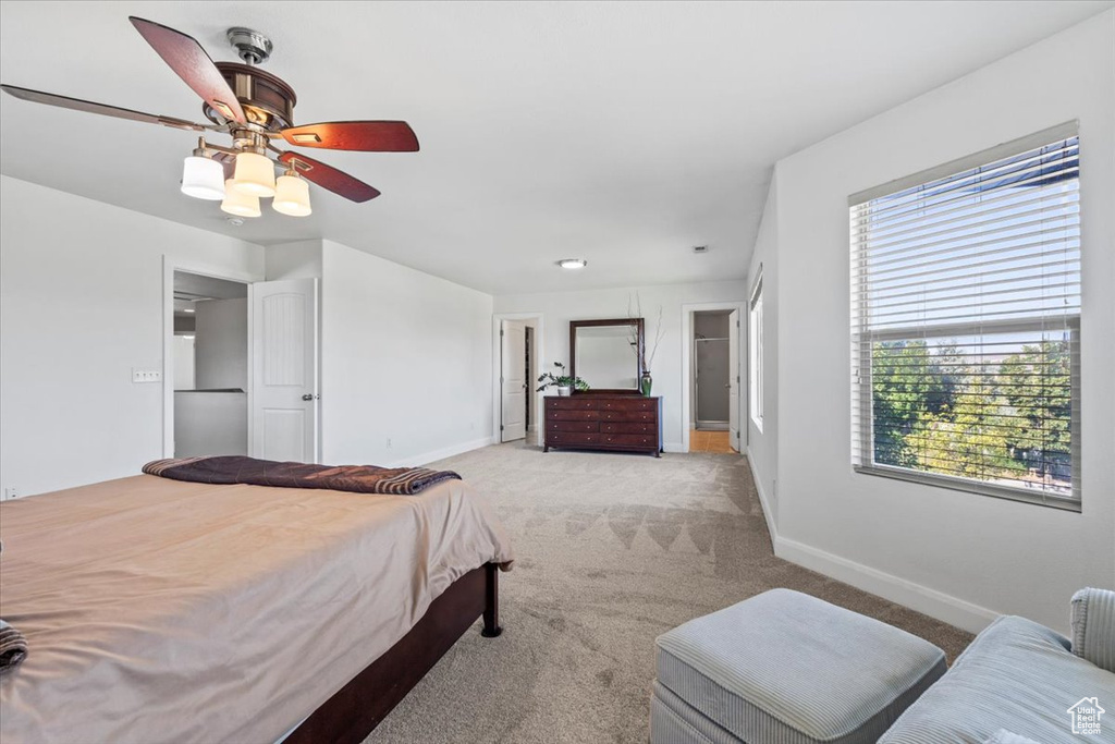 Bedroom with light carpet and a ceiling fan