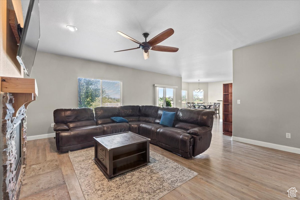 Living room with ceiling fan and light wood finished floors