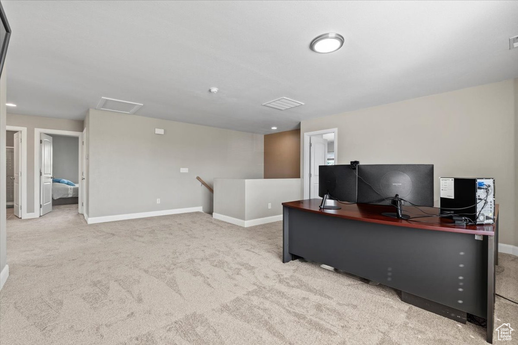 Carpeted home office featuring baseboards and attic access