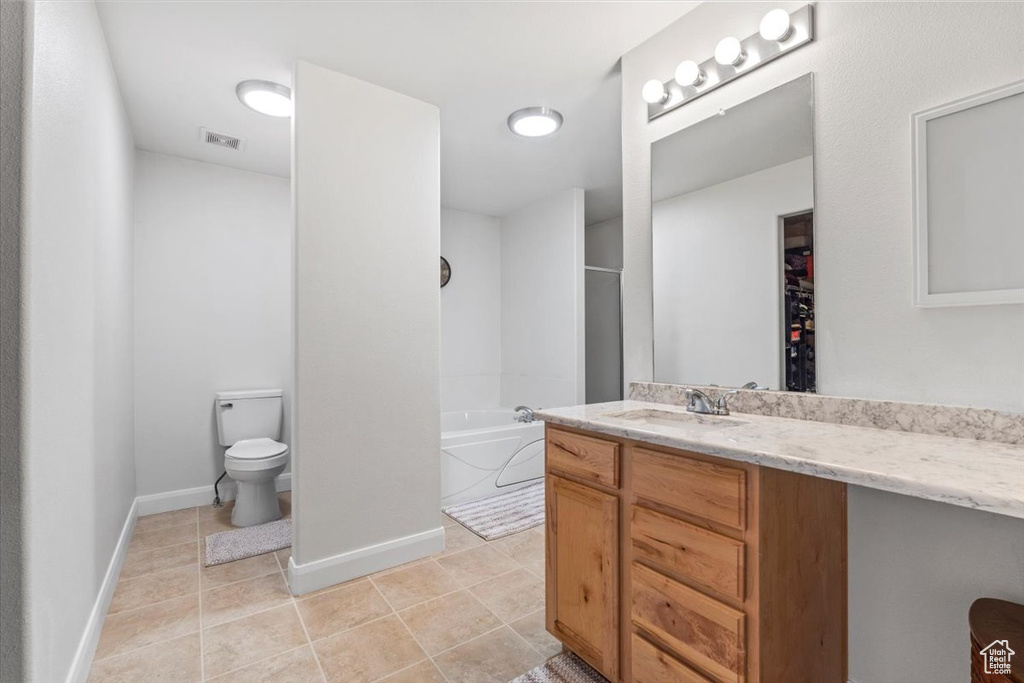 Bathroom featuring a bathtub, vanity, tile patterned flooring, and a shower