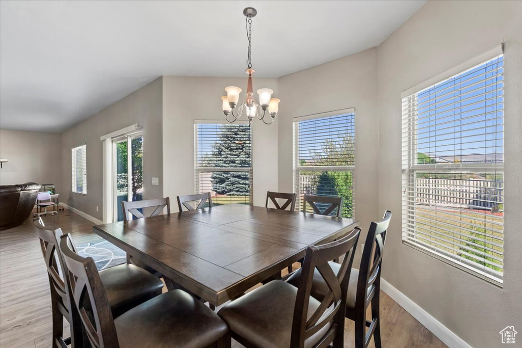 Dining room with a chandelier and light wood-type flooring