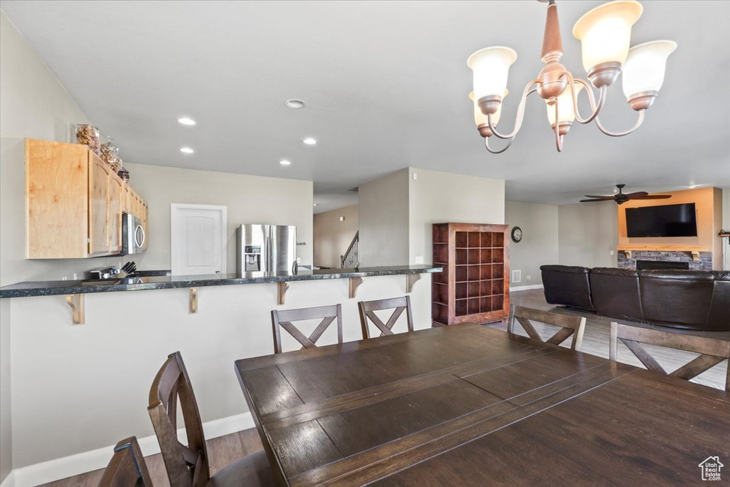 Dining room featuring ceiling fan, recessed lighting, a chandelier, and wood finished floors