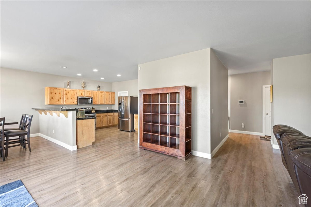 Living room featuring light wood finished floors and recessed lighting