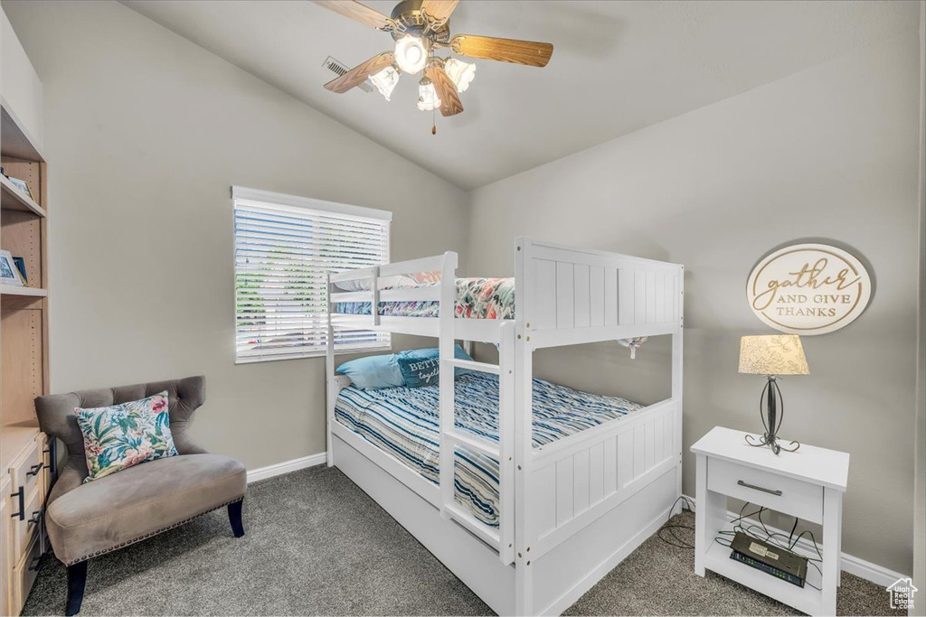 Bedroom with carpet, vaulted ceiling, and ceiling fan