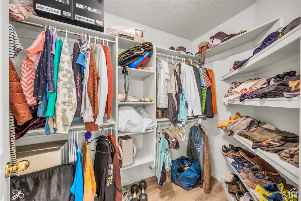 Spacious closet with wood finished floors