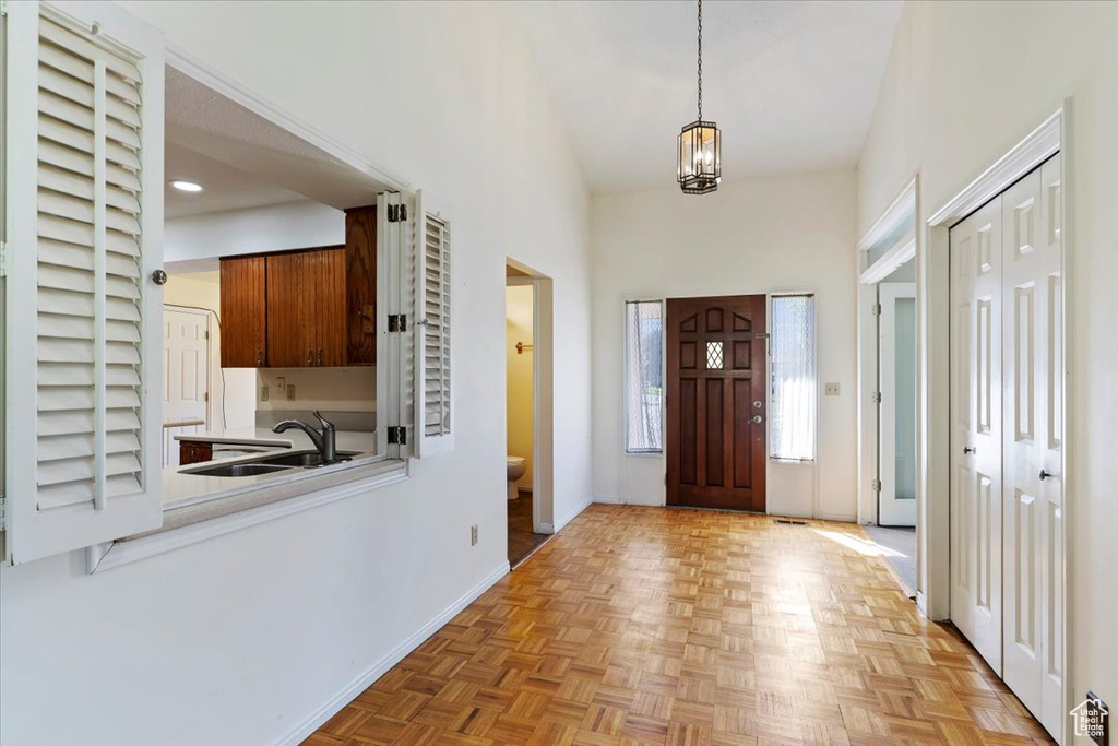 Foyer entrance with a chandelier and a towering ceiling